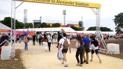 Spectators arrive at the stadium. AP