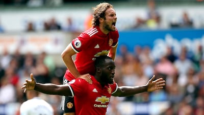 Manchester United's Romelu Lukaku, centre, celebrates scoring his side's second goal against Swansea City with teammate Daley Blind. Nick Potts / PA