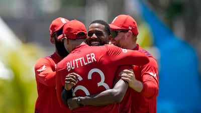 England's Chris Jordan is hugged by captain Jos Buttler after completing his hat-trick as USA were bowled out for 115 after 18.5 overs. AP