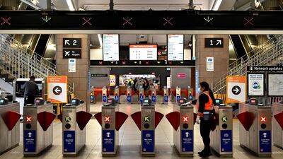 A worker disinfects gates to platforms at Circular Quay train station in Sydney. Australia has been relatively successful in containing the spread of the coronavirus, with about 27,500 cases and 905 deaths in a population of 25 million. AFP