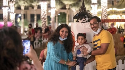 Visitors get in the spooky spirit at the Town Square Halloween event.