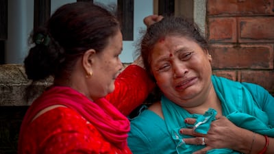 A woman cries outside Maharajgunj Medical Campus.
