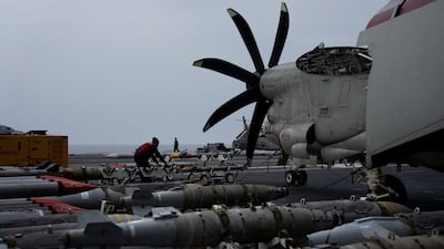 A sailor handles missiles on the USS George Washington aircraft carrier in the Arabian Sea, on September 13. Reuters