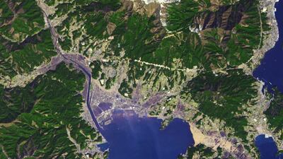 22. A satellite image taken after a 9.1 magnitude earthquake struck the Tohoku region in Japan, with tsunami waves destroying most of the coastal area. About five to 10 metre waves flooded into the town. The photo shows flooding, a destroyed seawall and debris. Photo: Nasa Earth Observatory