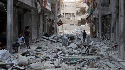 Residents inspect a damaged site after an airstrike in the besieged rebel-held al-Qaterji neighbourhood of Aleppo, Syria October 14, 2016. Abdalrhman Ismail /Reuters