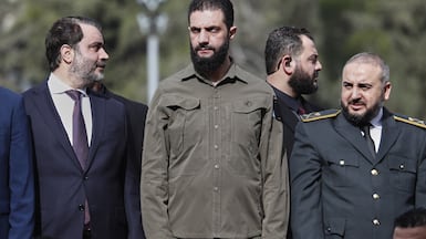 Syrian President Ahmad Al Shara, centre, with Defence Minister Murhaf Abu Qasra, right, and Foreign Minister Asaad Al Shibani, during celebrations in Damascus. AP