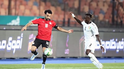 Egypt's Mohamed Salah, left, in action against Guinea's Issiaga Sylla. EPA