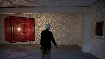 A man watches an art by Anila Quayyum Agha during India Art Fair in New Delhi, India. The four day art fair brings together a number of modern and contemporary artists to present their works. Tsering Topgyal / AP photo