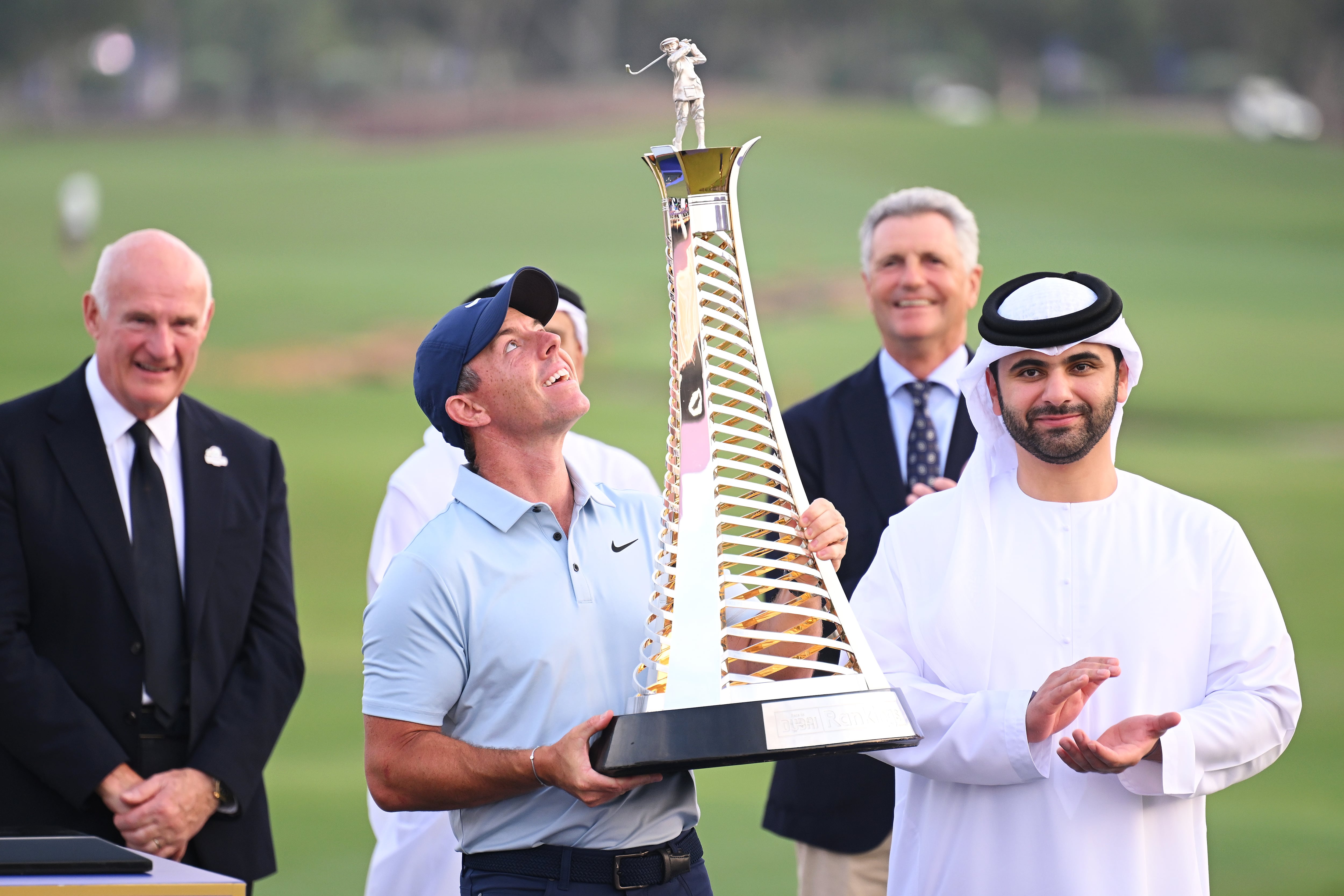 Rory McIlroy is presented with the Race to Dubai trophy on the 18th green at Jumeirah Golf Estates. Getty Images