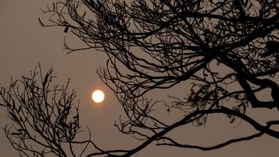 The sun is shrouded by haze of smoke from bushfires in Mallacoota. Getty Images