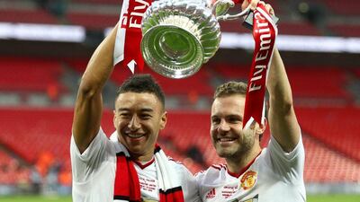 Goalscorers Jesse Lingard (L) and Juan Mata of Manchester United celebrate with the trophy after winning the FA Cup on Saturday. Paul Gilham / Getty Images / May 21, 2016