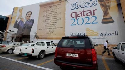 A banner promoting the Qatar 2022 World Cup adorns a building in Doha as the city prepares to host the Asian Cup.
