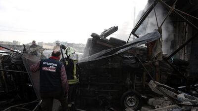 Rescuers work at the site of airstrike targeting the centre in the industrial area in the east of Idlib. EPA