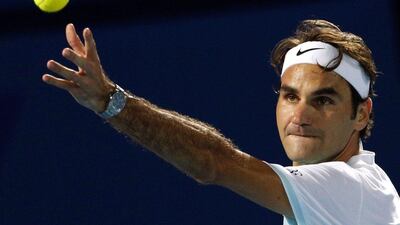 Switzerland's Roger Federer of Obi UAE Royals returns the ball to Croatia's Ivo Karlovic of Philippine Mavericks during their International Premier Tennis League (IPTL) tennis match on December 14, 2015 in the Emirate Dubai. AFP PHOTO / KARIM SAHIB