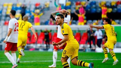 Dortmund's Portuguese defender Raphael Guerreiro, centre, celebrates after Erling Braut Haaland scored against Fortuna Duesseldorf. AFP