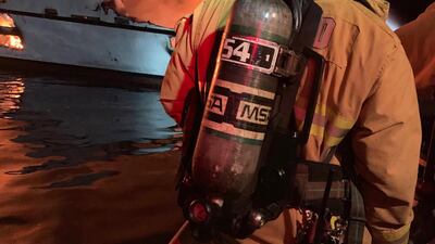 In this photo released by the Ventura County Fire Department on September 2, 2019, Firefighters attempt to extinguish a fire on a boat off the coast of Santa Cruz Island, California. AFP PHOTO / Ventura County Fire Department