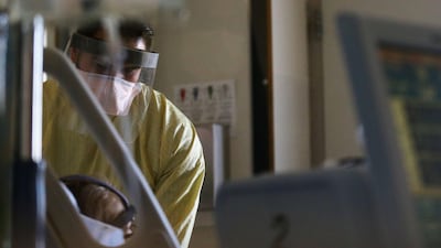 Registered nurse Eduardo Eran cares for a Covid-19 patient in the Covid ward at Sharp Chula Vista Medical Center in December. AFP