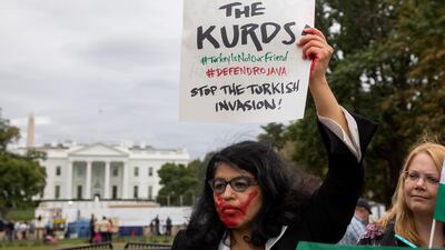 A woman joins other people protesting against an expected military incursion by Turkey into Kurdish areas of northern Syria, at Lafayette Square in front of the White House in Washington. EPA
