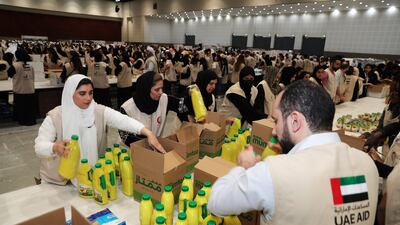Volunteers pack essential supplies for those affected by the earthquake in Syria and Turkey at Dubai World Trade Centre. Pawan Singh / The National