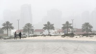 People at the Jumeirah open beach during the sandstorm in Dubai. Pawan Singh / The National