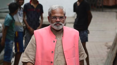 Abhinandan Pathak walks on a street as he campaigns. AFP