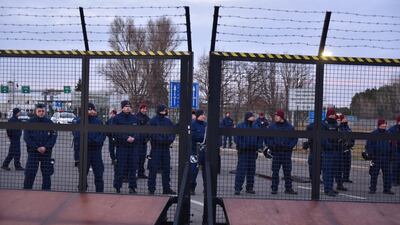 Hungarian policemen guard a closed gate at the border station of Kelebia-Tompa on Thursday. EPA