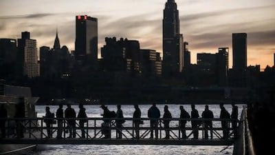 People board a NY Waterways ferry with the Manhattan skyline in the background. The ‘Frankenstorm’ Sandy left parts of the state and the surrounding area without power.