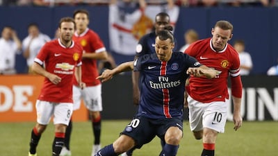 Zlatan Ibrahimovic, left, keeps the ball away from Wayne Rooney, right, in the first half of the International Champions Cup match Kamil Krzaczynski / AP Photo