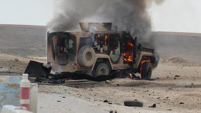 A military vehicle is on fire at the scene of a suicide car bomb attack on a military convoy on a road in Syria's northeastern Hasakeh province, which killed five members of a Kurdish-led force accompanying US-led coalition troops. AFP