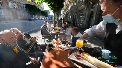People enjoy a breakfast at a cafe in Strasbourg, eastern France. AP Photo