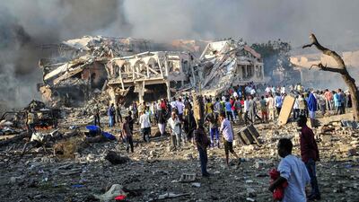 Men and Somalian soldiers arrive on the site to rescue victims of the explosion of a truck bomb in the centre of Mogadishu. Mohamed Abdiwahab / AFP Photo