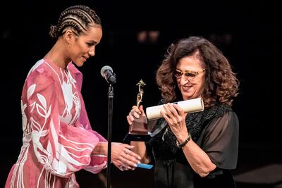 Egyptian filmmaker and producer Marianne Khoury, right, receives the Audience Award from British actress Nathalie Emmanuel during the closing ceremony of the 41st Cairo International Film Festival in 2019. AFP