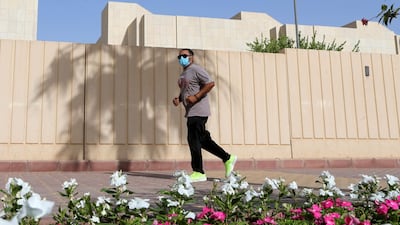 A man wears a protective face mask while jogging in Riyadh, Saudi Arabia. Reuters