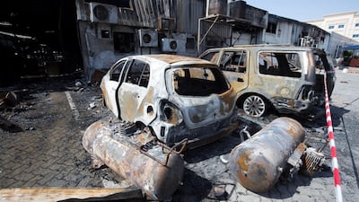 A fire erupted in three cars and spread to three warehouses near Dubai International Airport. Ruel Pableo for The National
