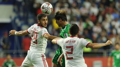 Iran forward Karim Ansarifard, centre, contests a head with Iraq forward Mohammed Dawood, left. AP Photo