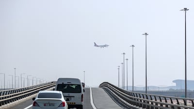 A plane descends towards Abu Dhabi International Airport on a slightly hazy morning. Victor Besa / The National