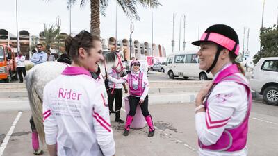 Grooms and riders prepare the horses for the closing ceremony of the Pink Caravan Ride 2017 at Zayed Sports City in Abu Dhabi on March 17, 2017. Reem Mohammed / The National