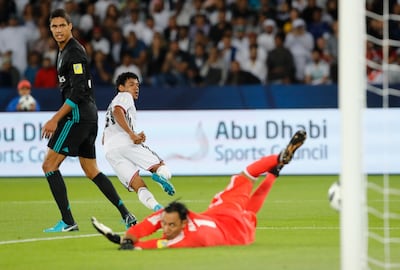 Al Jazira's Romarinho, left, scores the opening goal against Real Madrid in the Fifa Club World Cup semi-final at Zayed Sports City. Hassan Ammar / AP Photo