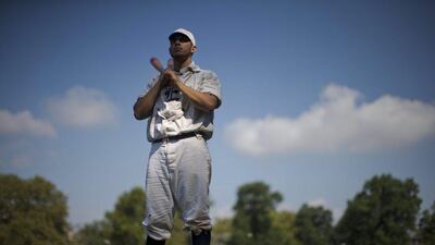 Vintage baseball player Matt Fischetti with the Resolute Base Ball Club of Elizabeth, New Jersey, waits for his turn to bat during the 2014 Base-Ball Exhibition & Fair at the Navy Yard in Philadelphia. The clubs play baseball according to rules of the game as it was played in 1864. Matt Rourke / AP