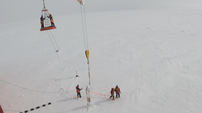 Researchers from NYUAD's Centre for Global Sea Level Change on their way to retrieve a mast installed on sea ice in the Southern Ocean in 2019.