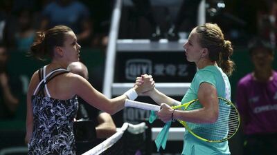Svetlana Kuznetsova, right, shakes hands with Agnieszka Radwanska after an eventful opening match in the WTA Finals. Wallace Woon / EPA