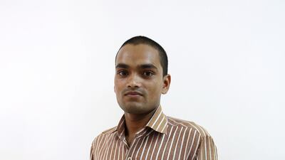Anup Kumar, a pipe fitter from Uttar Pradesh, India, has his portrait taken at Al Quoz Industrial Area in Dubai. Pawan Singh / The National