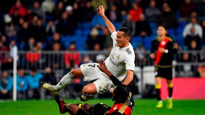 Real Madrid midfielder Lucas Vazquez is tackled by Rayo Vallecano defender Abdoulaye Ba. AFP
