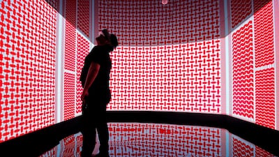 A visitor tests a virtual reality headset at the Saudi Telecom Company area at the Mobile World Congress. AFP