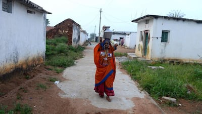 Widow P. Jamunamma, who lost her husband in a road accident, carries a vessel filled with drinking water in the village of Peddakunta, some 56 kilometers from Hyderabad. Noah Seelam / AFP