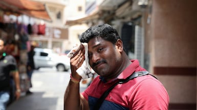 Residents in Bur Dubai during extreme summer heat, Dubai. Chris Whiteoak / The National