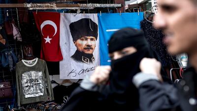 People walk in front of the picture of Mustafa Kemal Ataturk as they shop at Eminonu bazaar in Istanbul. President Recep Tayyip Erdogan announced that Turkey will hold the snap election on 24 June 2018. Sedat Suna / EPA