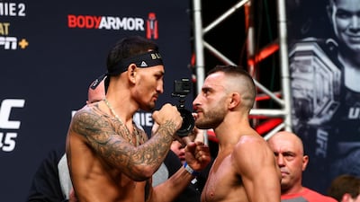 Max Holloway, left, and Alexander Volkanovski face off during the ceremonial weigh-in