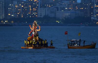 Hindu devotees prepare to immerse an idol of the elephant-headed god Ganesh in the Arabian Sea off Mumbai on September 12, 2019. AP Photo