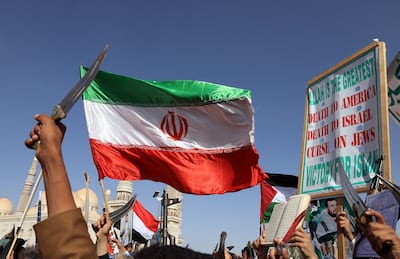 Houthi supporters wave an Iranian flag during a protest in Sanaa. EPA